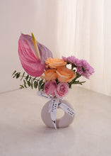 Load image into Gallery viewer, Vibrant Blooms in baby donut vase
